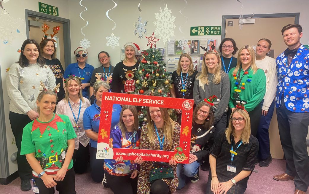 Staff smiling whilst wearing festive clothes