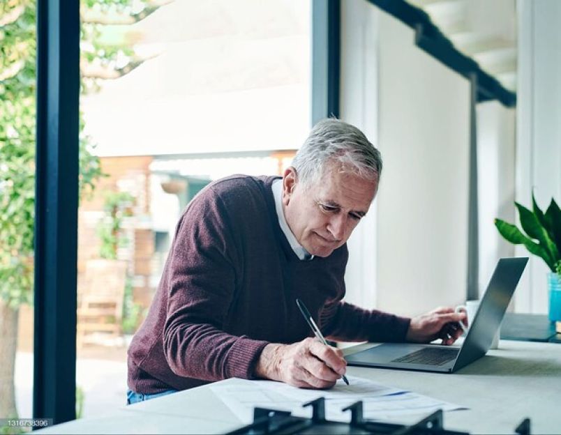 Man sitting at home writing his Will 