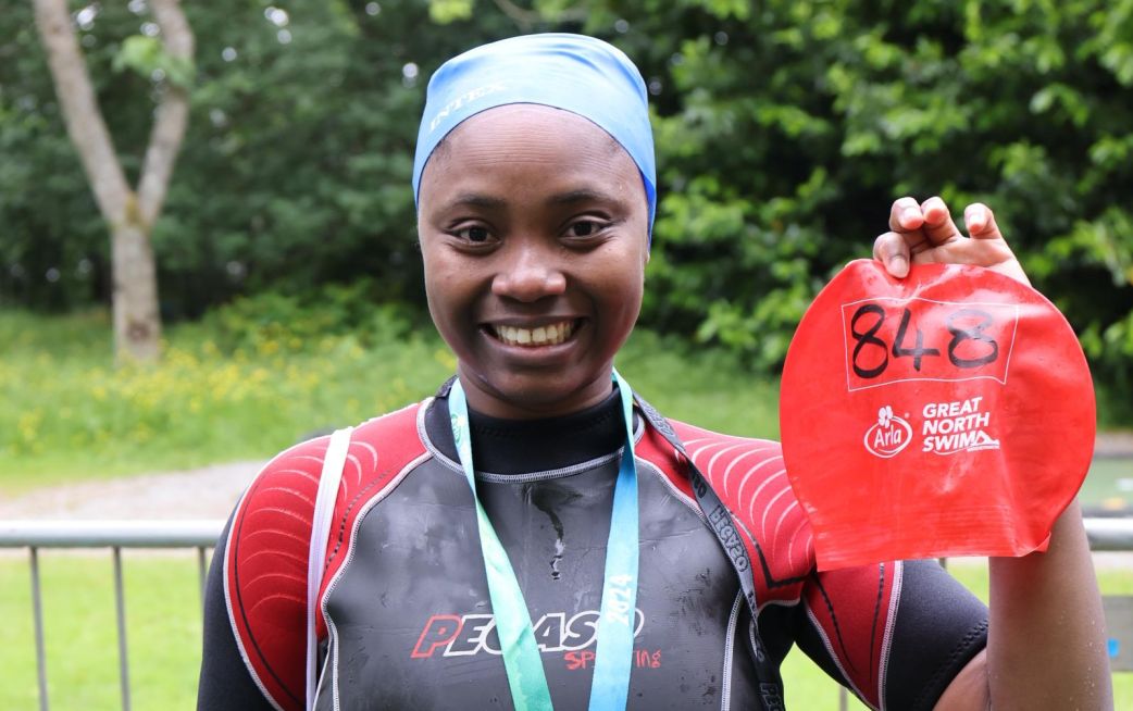 Runners smiling in charity running vests