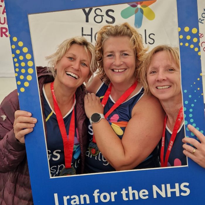 Runners taking a selfie with a selfie frame