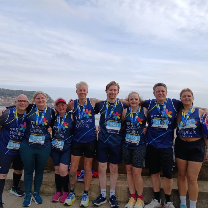 a group of runners with their Yorkshire Coast 10k medals