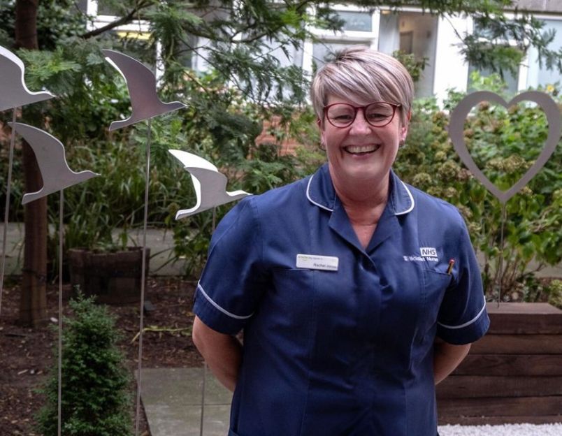 nurse smiling in garden funded by charity