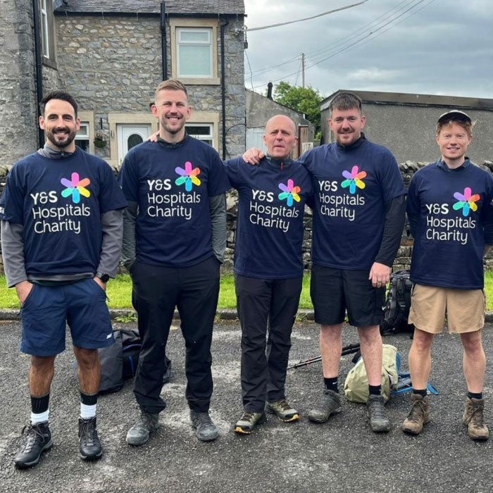 5 men in charity shirts