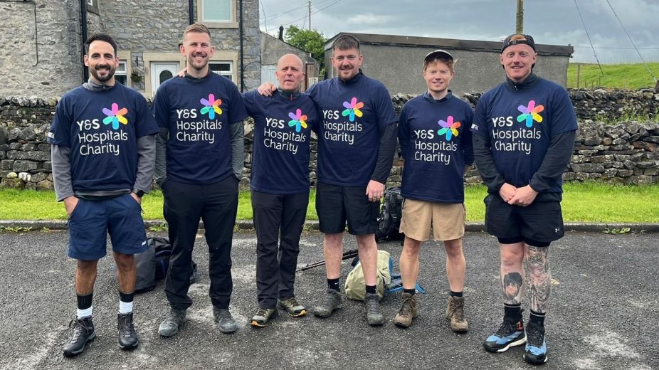 5 men in charity shirts