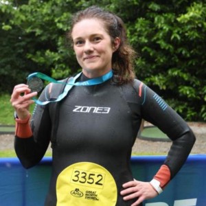 nicola holding medal after completing the swim