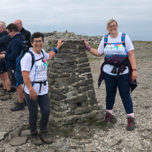 two walkers at the top of one of the three peaks