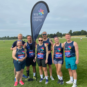 Team of runners in charity running vests before york 10k