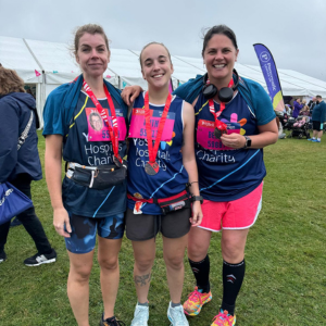 three runners holding medals after completing the Great North Run