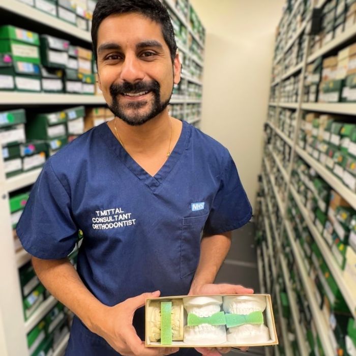 Consultant holding up 3D printed dental models 