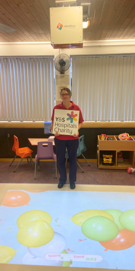 play team worker standing with projector