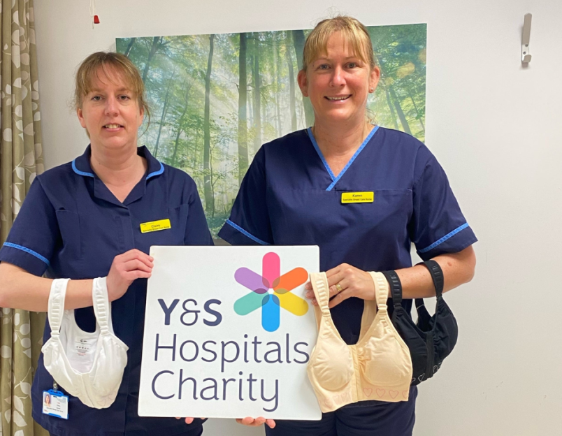 nurse holding charity sign and two post-mastectomy bras