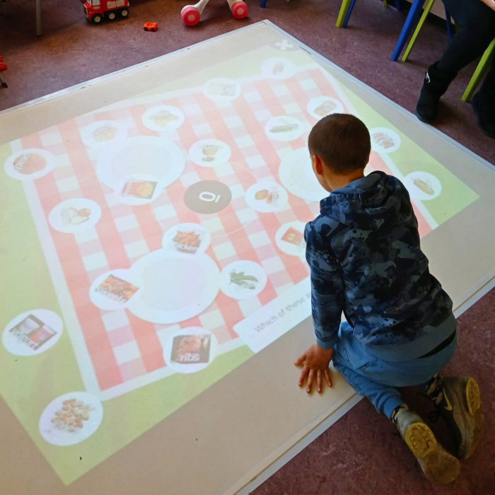 child playing with interactive projector