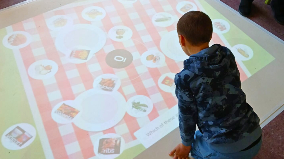 child playing with interactive projector